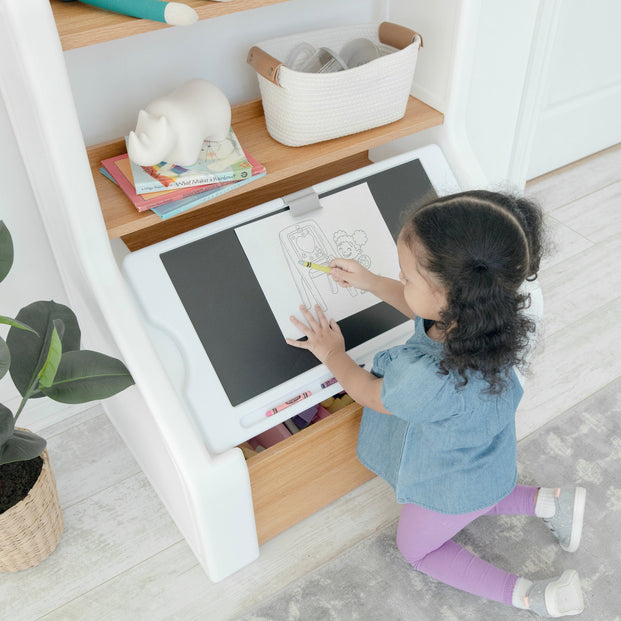 Girls using the art board on the Harmony Toy Storage Box